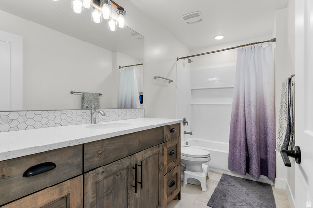 1426 South 1450th Street West Mapleton, UT 84664 - Photo 21 of 50 Bathroom featuring a spacious wood-finish vanity with a light-toned countertop, an integrated sink, and a hexagonal tile backsplash
