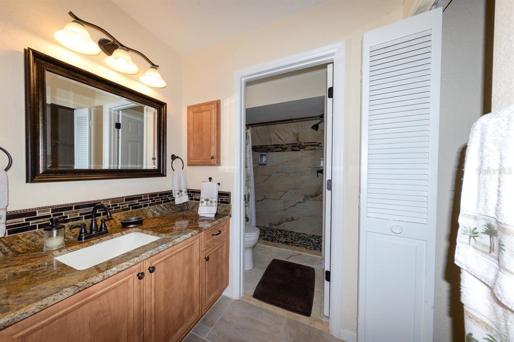 335 Coldeway Drive, Unit F21 Punta Gorda, FL 33950 - Photo 32 of 45 a spacious bathroom with a sink and a mirror