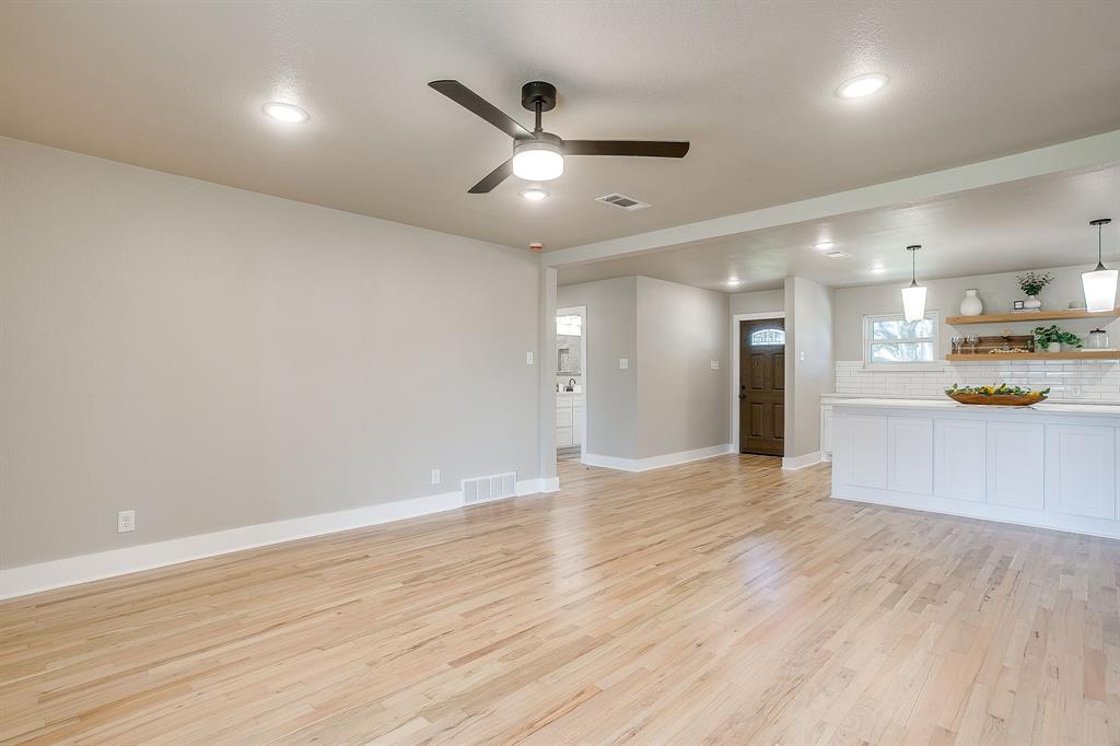 103 Vanshire Road West Lakeside, TX 76108 - Photo 14 of 39 an empty room with wooden floor and a kitchen