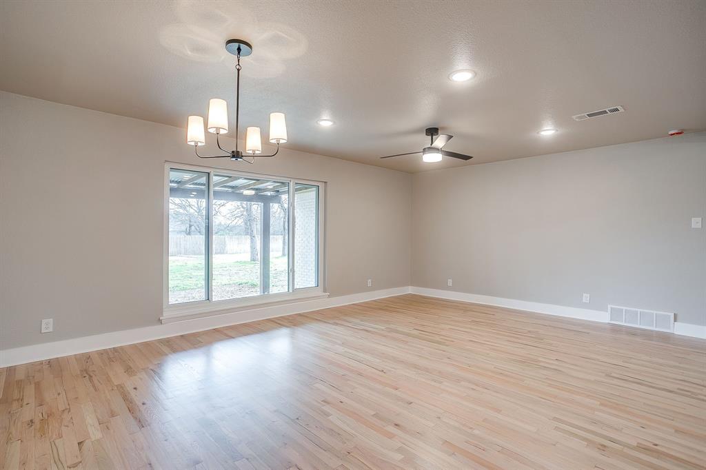 103 Vanshire Road West Lakeside, TX 76108 - Photo 17 of 39 an empty room with wooden floor a ceiling fan and windows