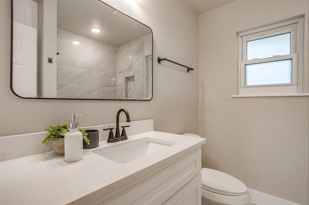 103 Vanshire Road West Lakeside, TX 76108 - Photo 27 of 39 a bathroom with a granite countertop sink a toilet and a mirror