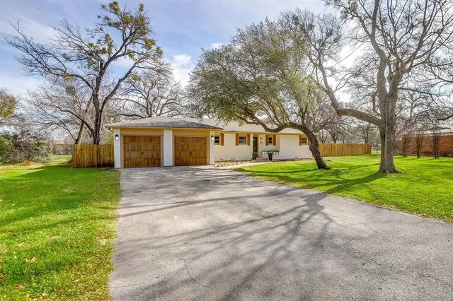 a front view of house with yard and green space
