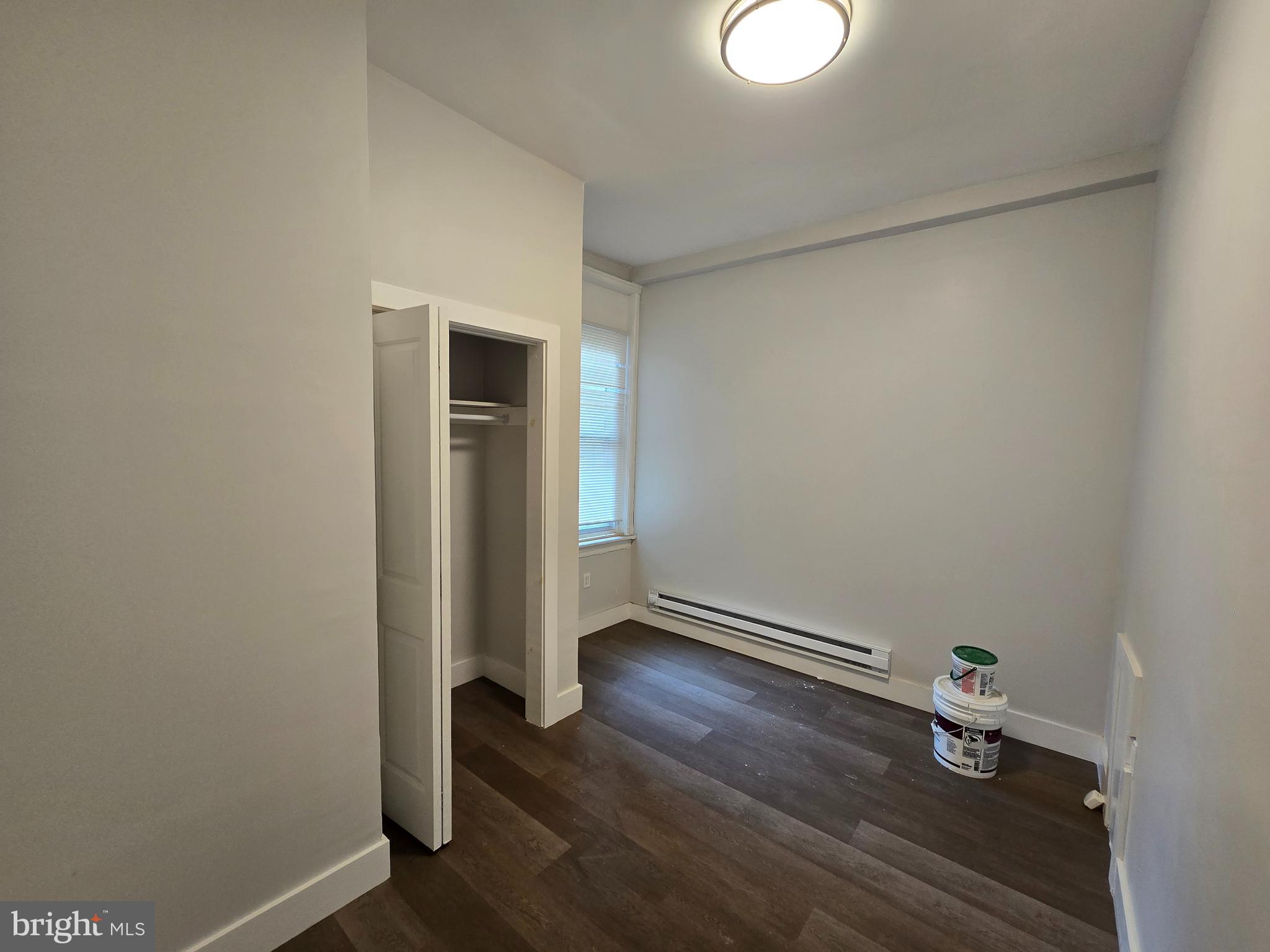 1321 West Wingohocking Street, Unit 1 Philadelphia, PA 19140 - Photo 13 of 19 a view of an empty room with wooden floor and a window