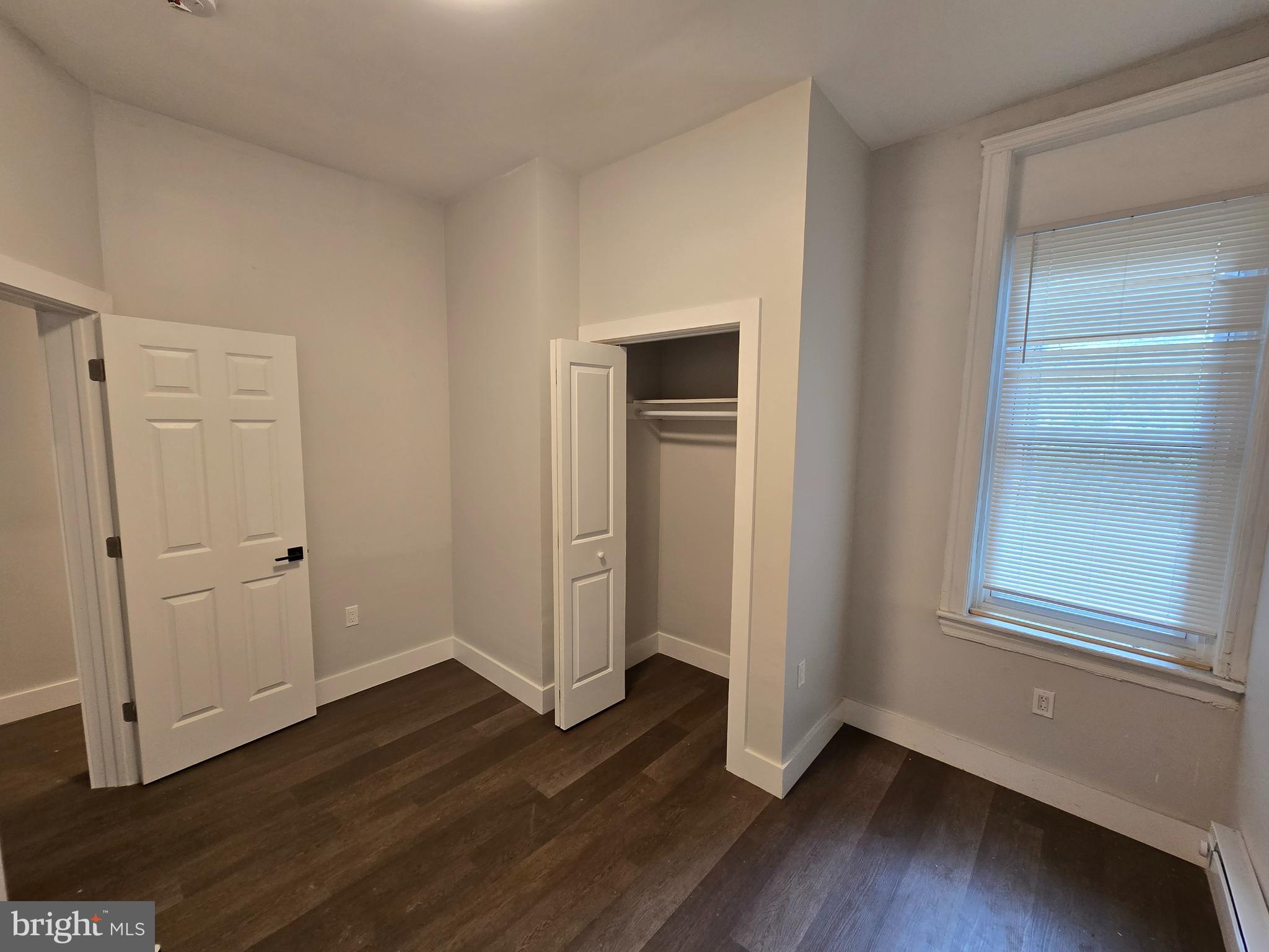 1321 West Wingohocking Street, Unit 1 Philadelphia, PA 19140 - Photo 14 of 19 a view of an empty room with wooden floor and closet