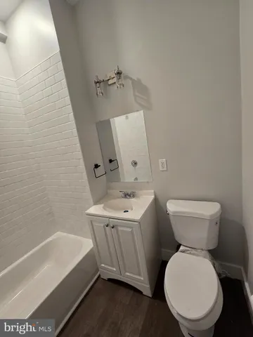 a bathroom with a toilet a sink and bathtub