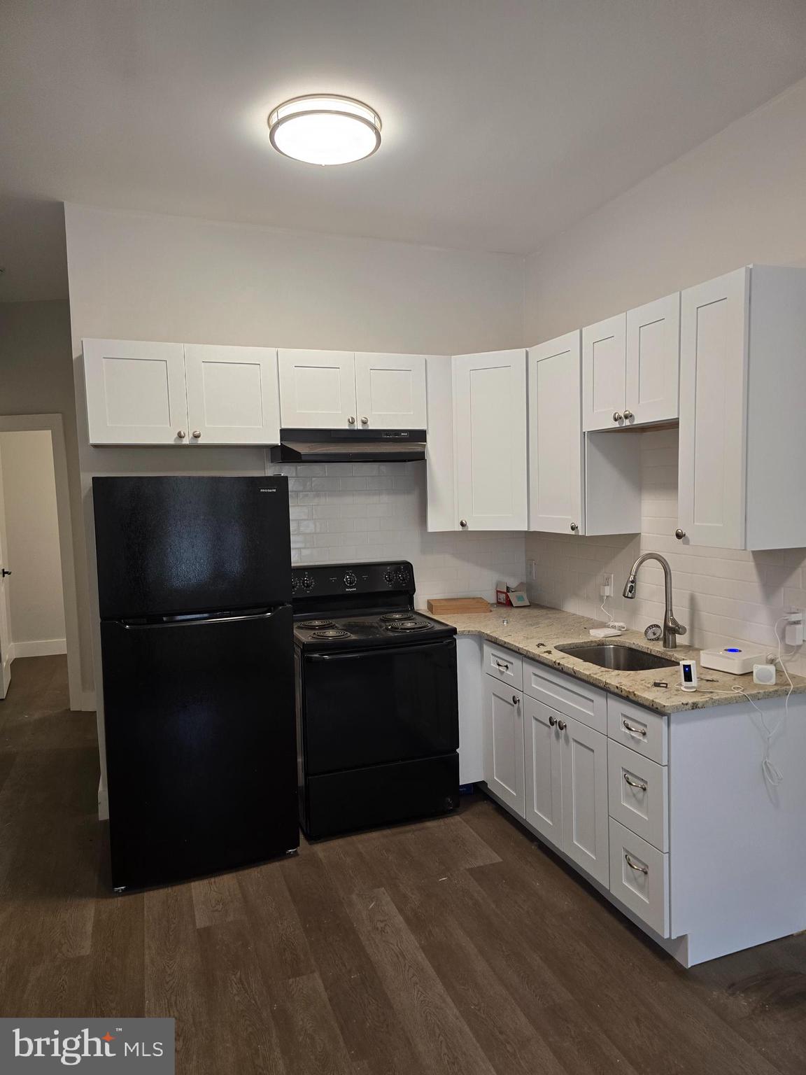 1321 West Wingohocking Street, Unit 1 Philadelphia, PA 19140 - Photo 6 of 19 a kitchen with a sink and stainless steel appliances