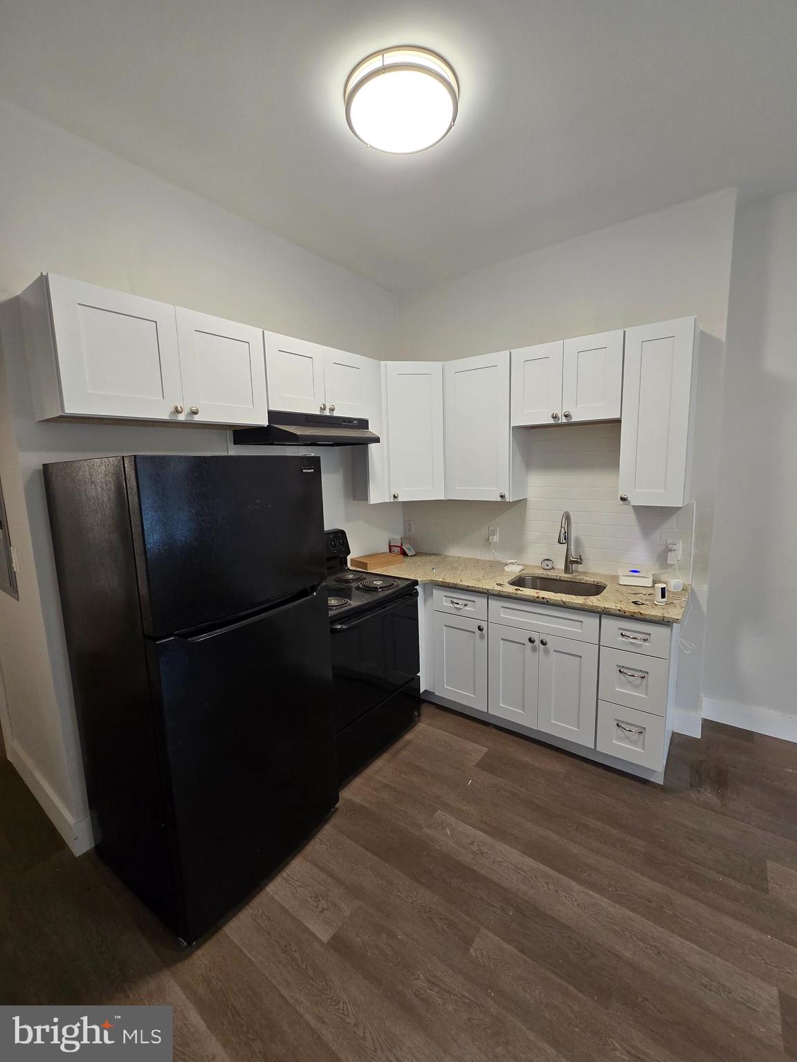 1321 West Wingohocking Street, Unit 1 Philadelphia, PA 19140 - Photo 8 of 19 a kitchen with a refrigerator and a stove top oven