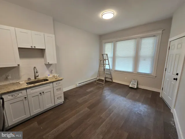 a kitchen with sink and cabinets