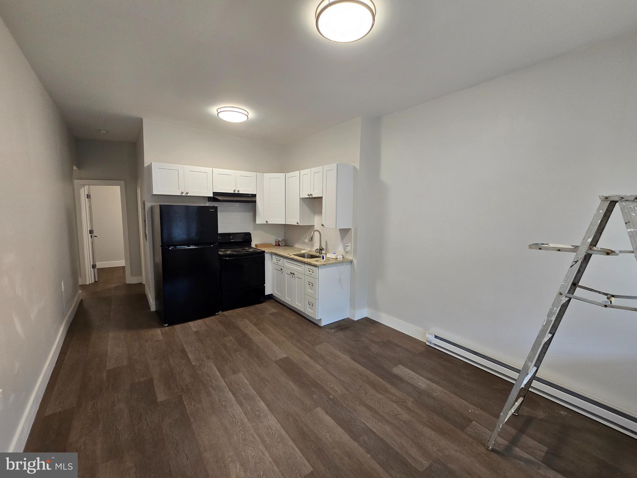 1321 West Wingohocking Street, Unit 1 Philadelphia, PA 19140 - Photo 10 of 19 a kitchen with stainless steel appliances a refrigerator and a stove top oven