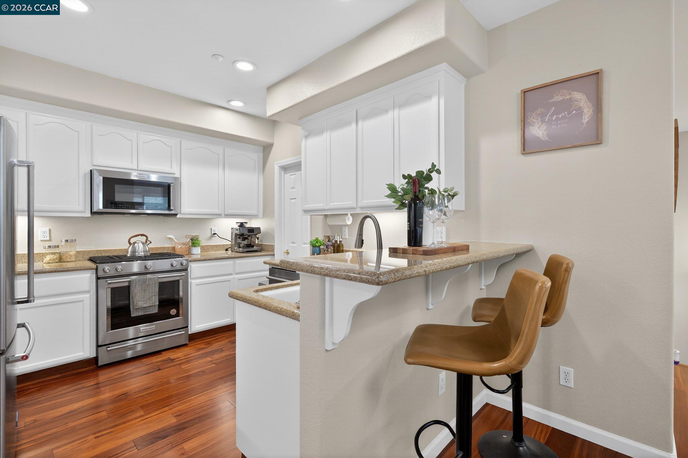 4300 Keegan Street Dublin, CA 94568 - Photo 13 of 33 a kitchen with stainless steel appliances a microwave a stove and white cabinets