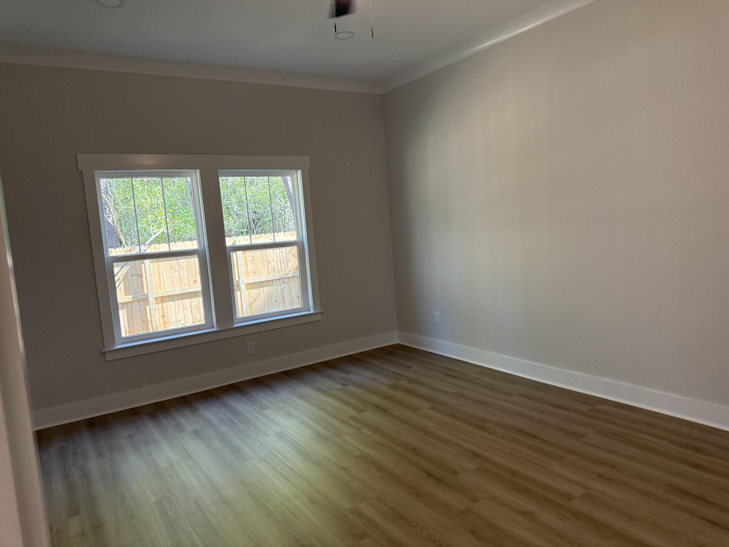 246 Foxglove Run Niceville, FL 32578 - Photo 18 of 40 an empty room with wooden floor and windows