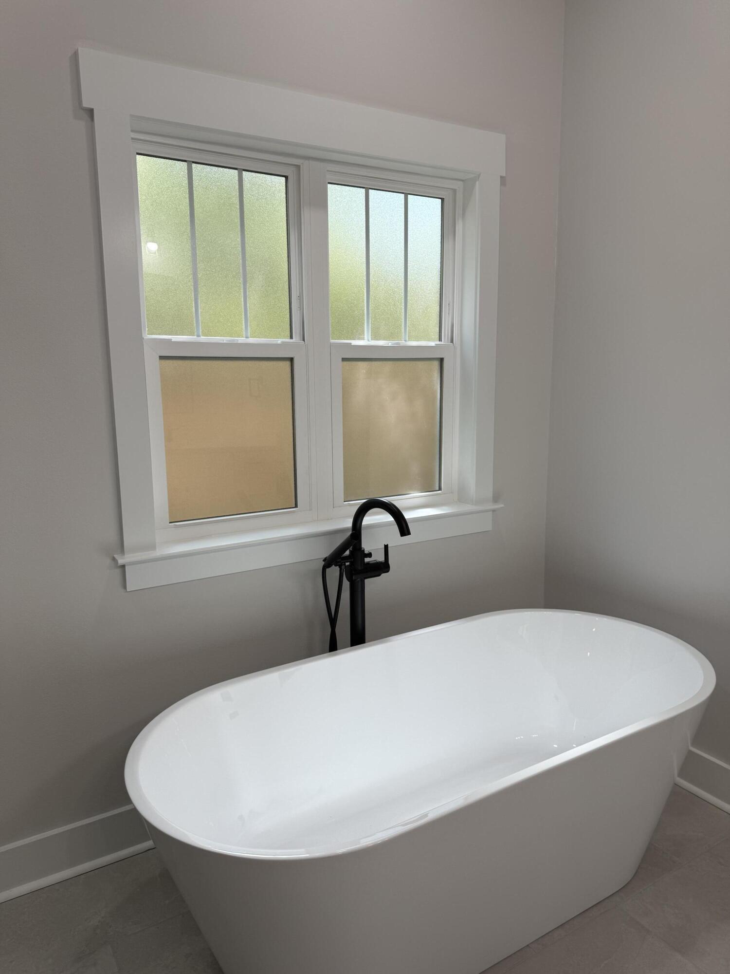 246 Foxglove Run Niceville, FL 32578 - Photo 23 of 40 a white tub sitting in a bathroom next to a window