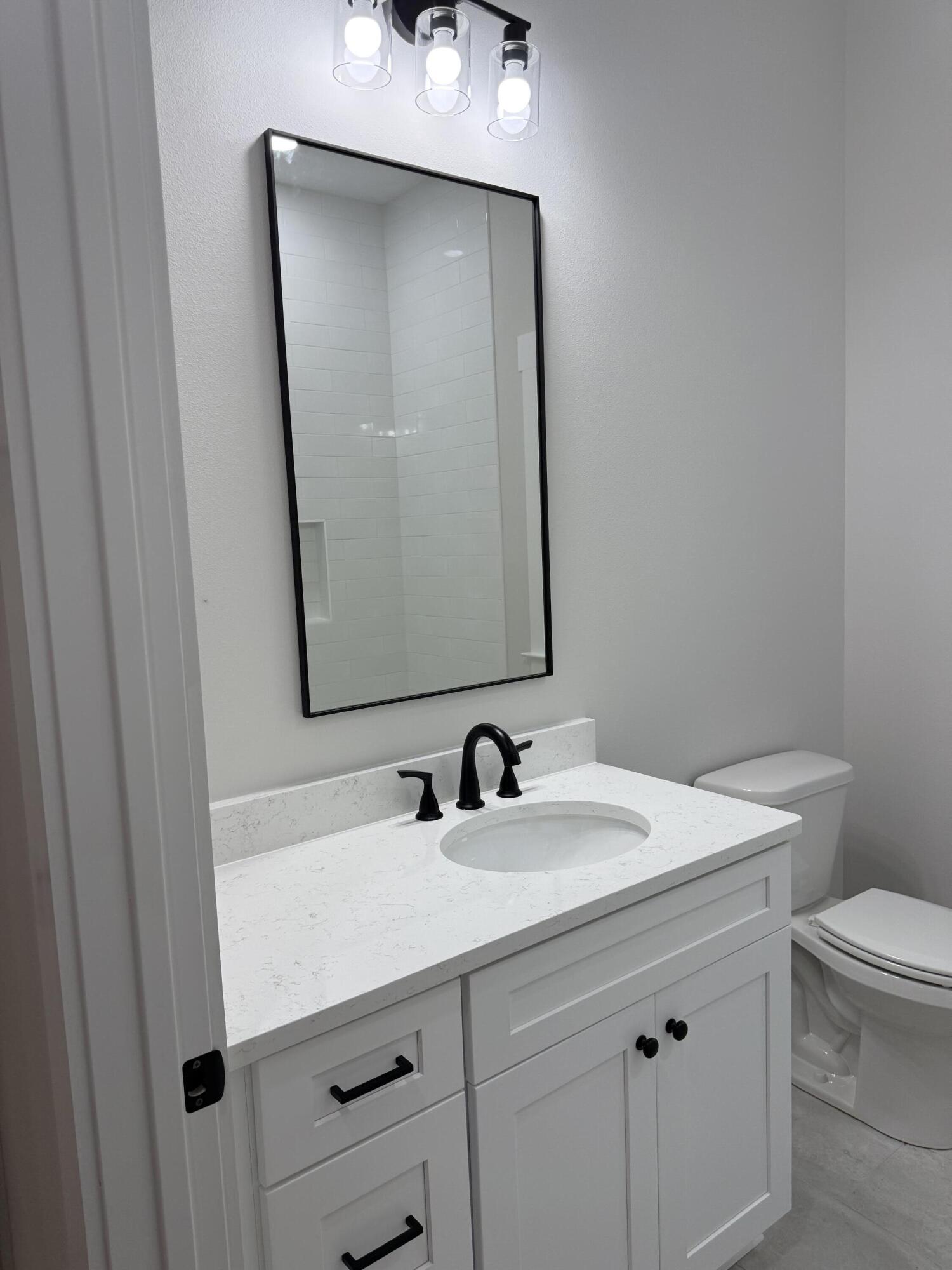 246 Foxglove Run Niceville, FL 32578 - Photo 28 of 40 a bathroom with a sink toilet and mirror