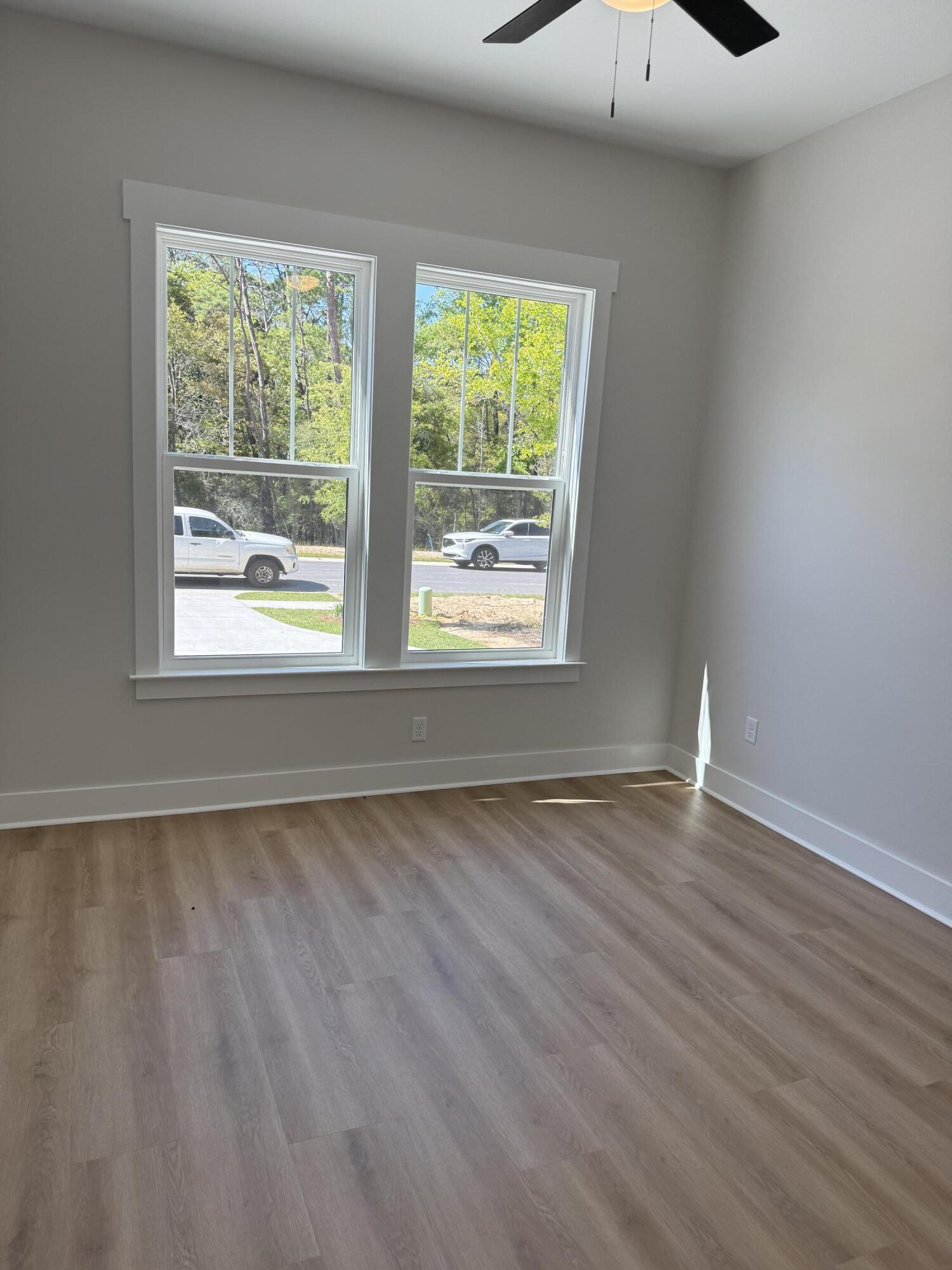 246 Foxglove Run Niceville, FL 32578 - Photo 30 of 40 a view of an empty room with wooden floor and a window