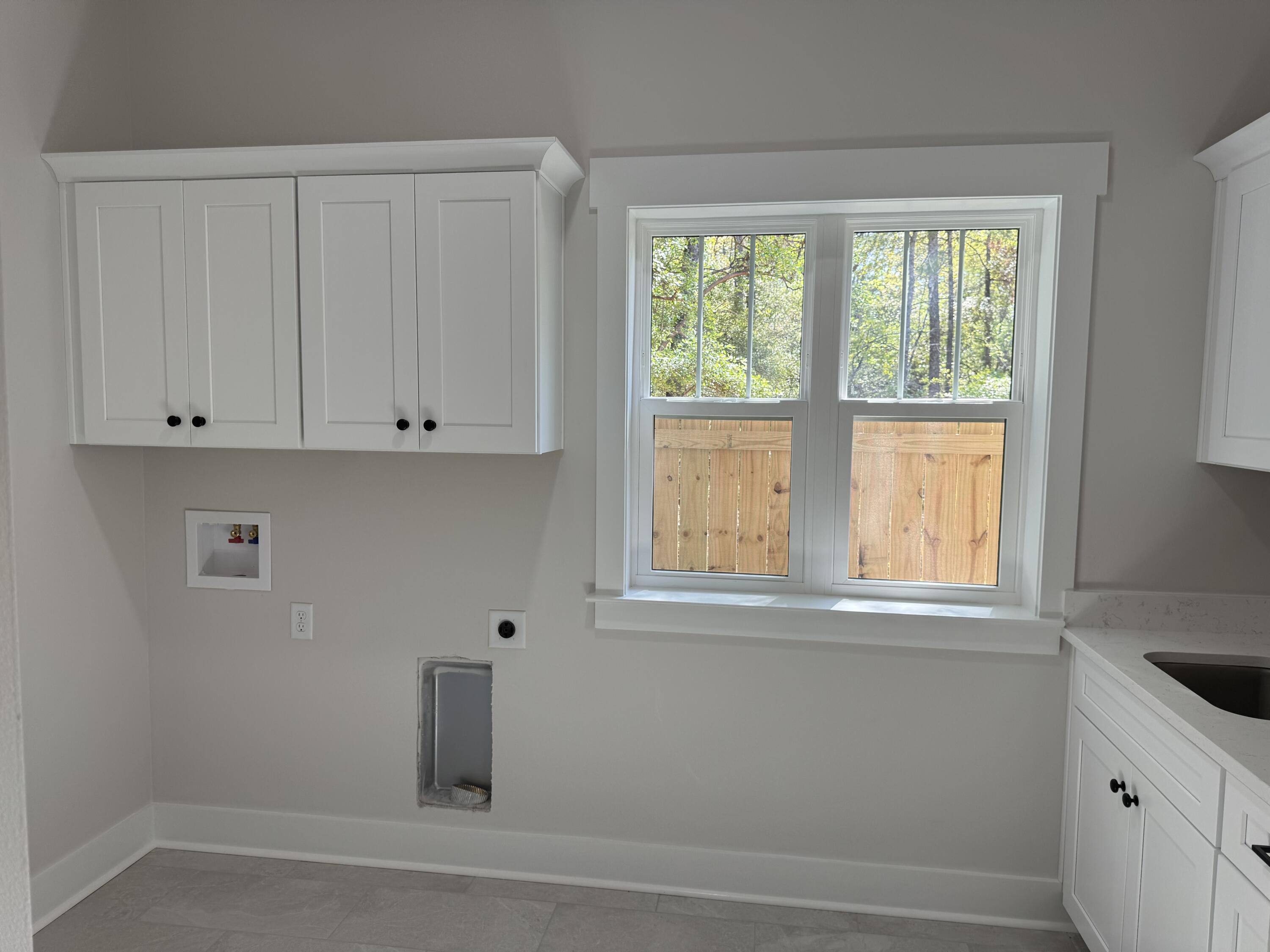 246 Foxglove Run Niceville, FL 32578 - Photo 33 of 40 a bathroom with a window and cabinets
