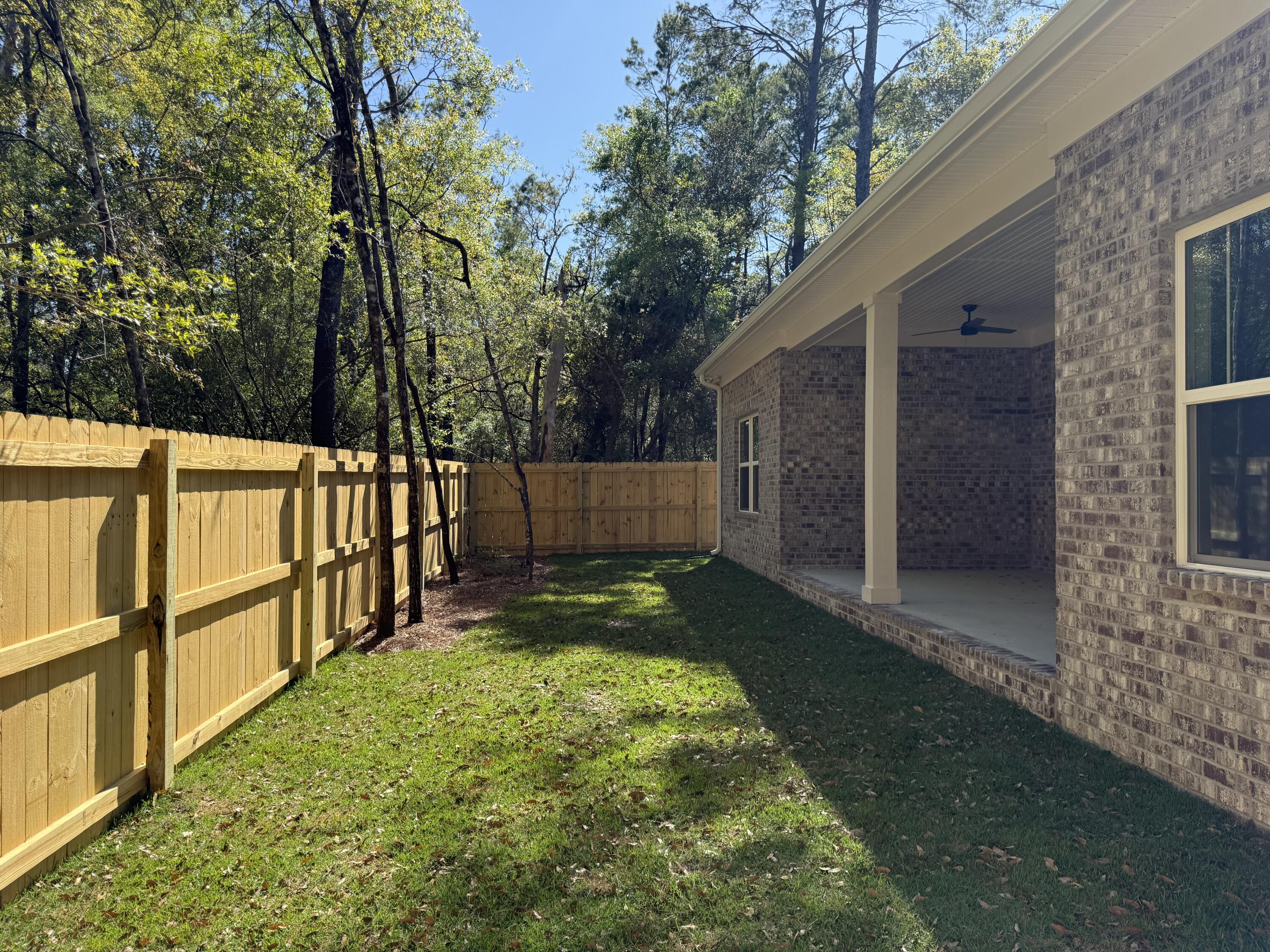246 Foxglove Run Niceville, FL 32578 - Photo 35 of 40 a view of backyard with wooden fence and large trees