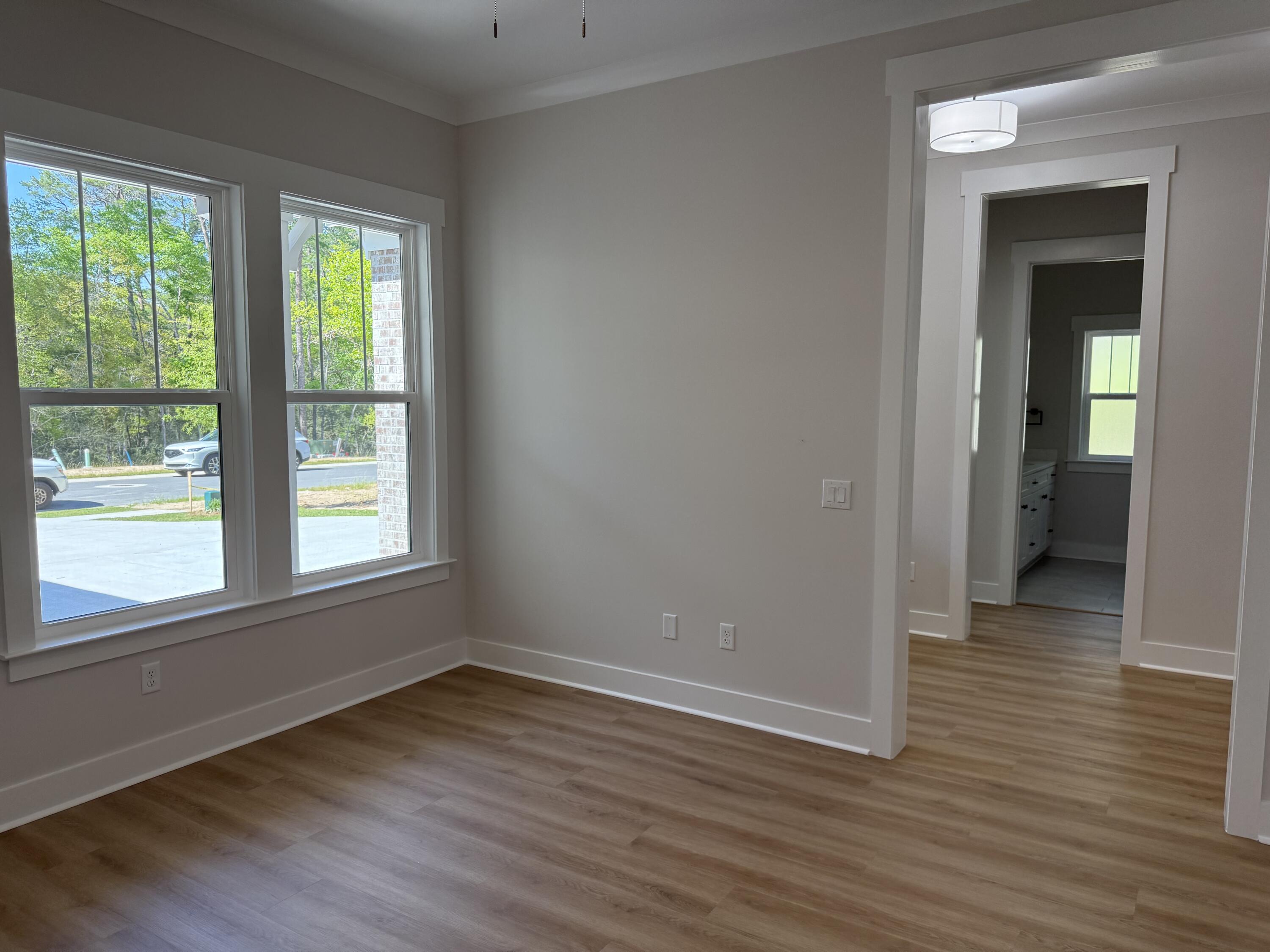 246 Foxglove Run Niceville, FL 32578 - Photo 6 of 40 a view of a room with wooden floor and windows