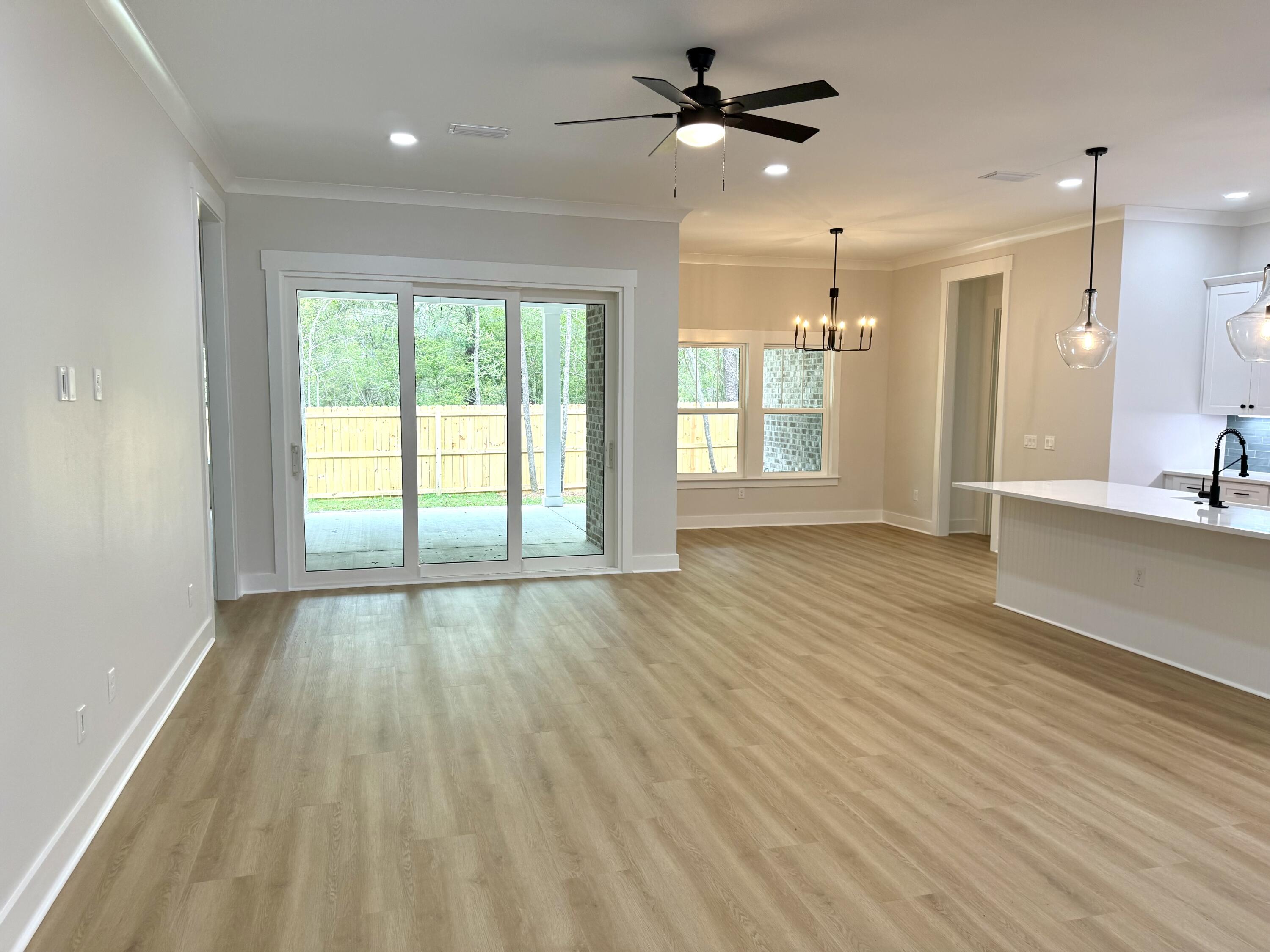 246 Foxglove Run Niceville, FL 32578 - Photo 7 of 40 a view of an empty room with glass door and chandelier fan