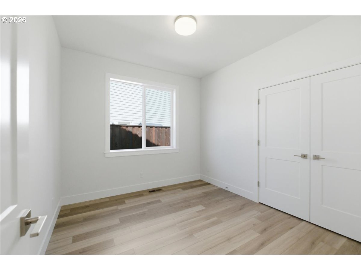 2147 Northeast Spitz Road Canby, OR 97013 - Photo 36 of 48 a view of an empty room with wooden floor and a window