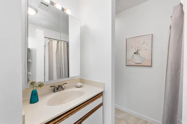 a en suite bathroom with a sink and a mirror