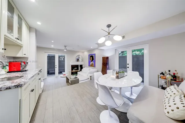 a living room with furniture a dining table and a fireplace