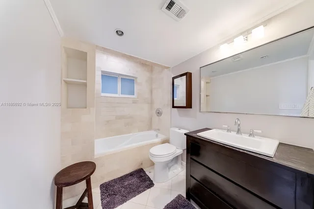 a bathroom with a sink a toilet and tub