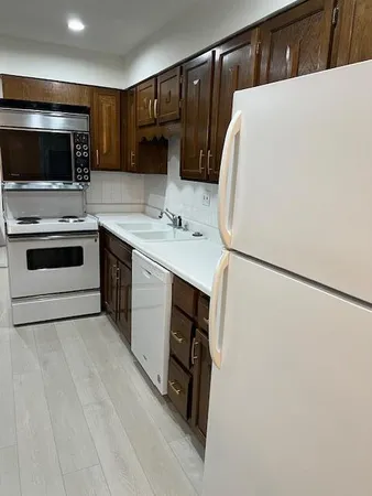 a kitchen with a sink and a refrigerator