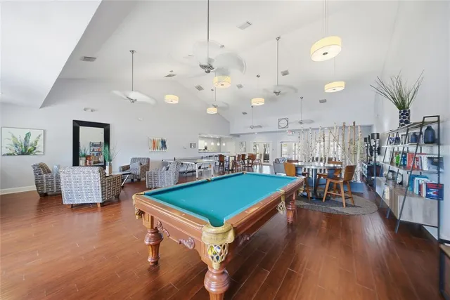 a living room with lots of furniture and kitchen view