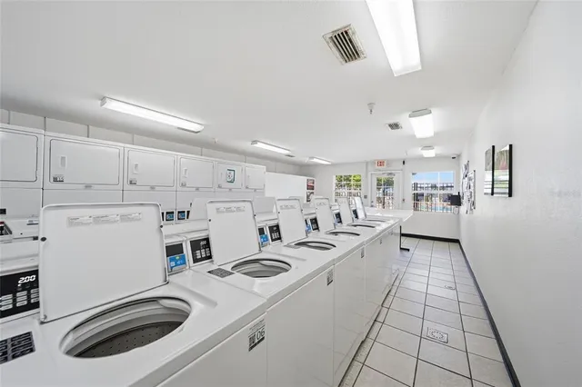 a kitchen with white cabinets a sink and white appliances