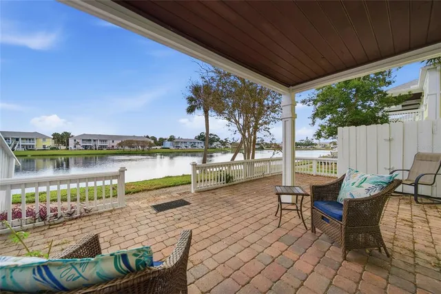 a swimming pool with outdoor seating and a patio
