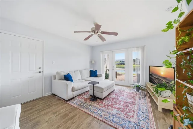 a living room with furniture a flat screen tv and a rug