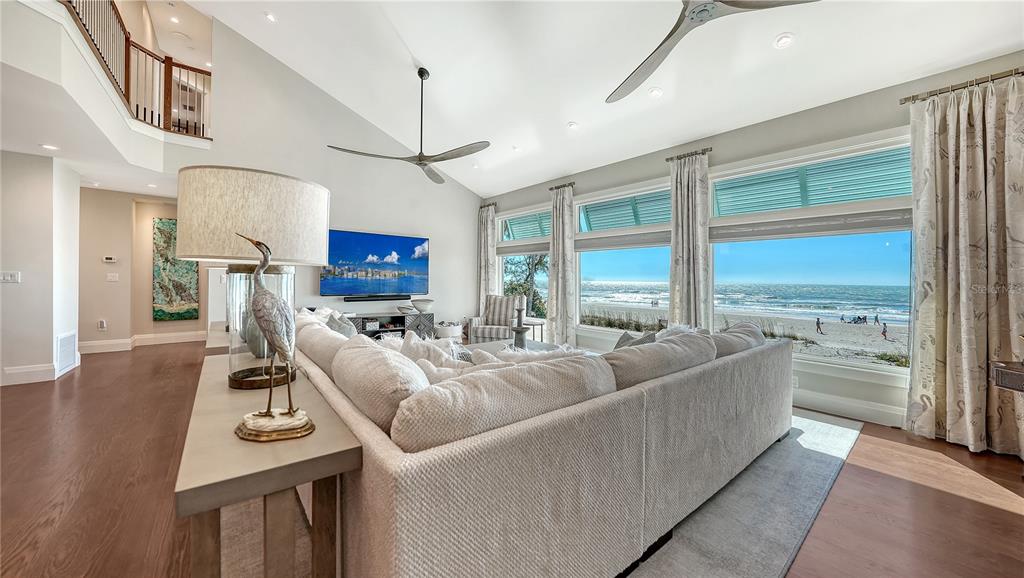 95 52nd Street Holmes Beach, FL 34217 - Photo 12 of 73 a living room with furniture a large window and a flat screen tv