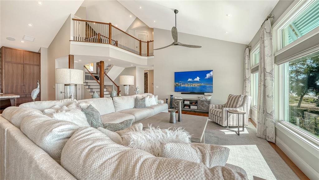 95 52nd Street Holmes Beach, FL 34217 - Photo 13 of 73 a living room with furniture a rug and a chandelier
