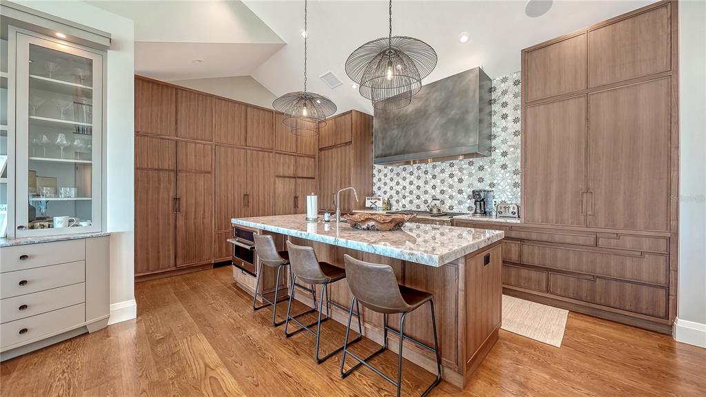 95 52nd Street Holmes Beach, FL 34217 - Photo 14 of 73 a kitchen with a table chairs and wooden floor