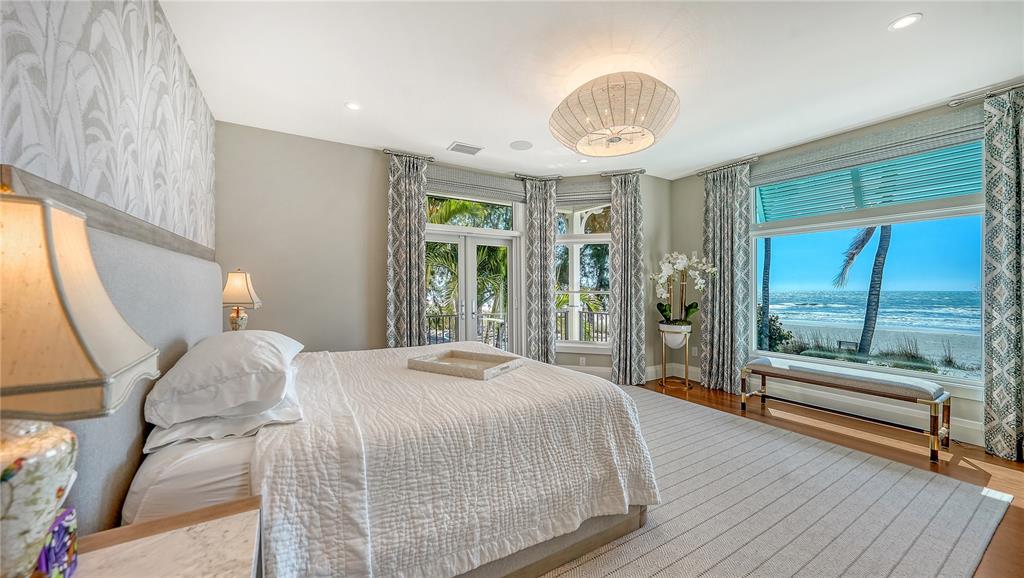 95 52nd Street Holmes Beach, FL 34217 - Photo 23 of 73 a bedroom with a large bed and a large window