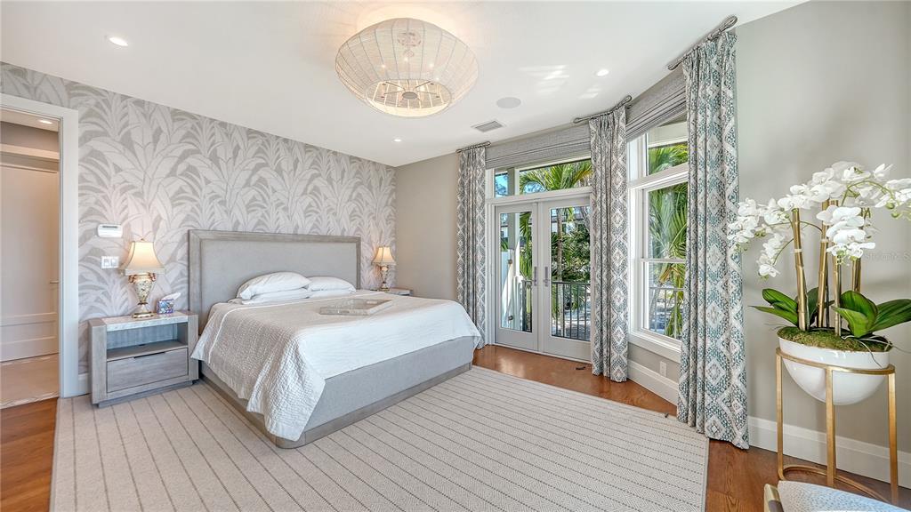 95 52nd Street Holmes Beach, FL 34217 - Photo 24 of 73 a bedroom with a large bed and a potted plant