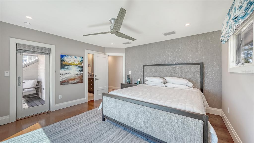 95 52nd Street Holmes Beach, FL 34217 - Photo 32 of 73 a bedroom with a large bed and a chandelier