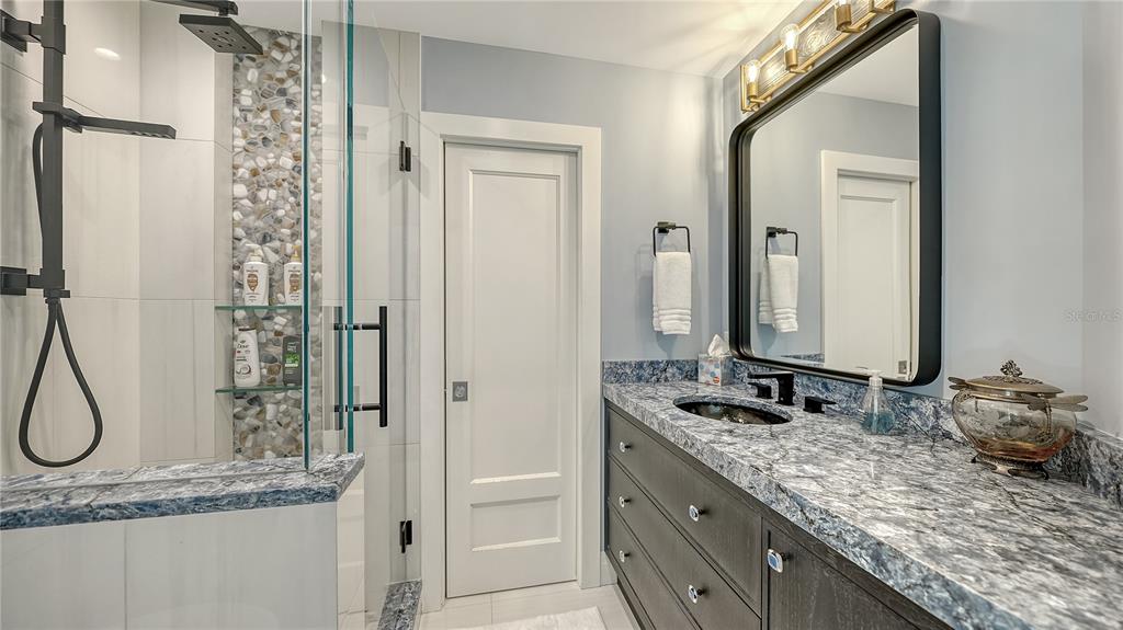 95 52nd Street Holmes Beach, FL 34217 - Photo 33 of 73 a bathroom with a granite countertop sink and a mirror