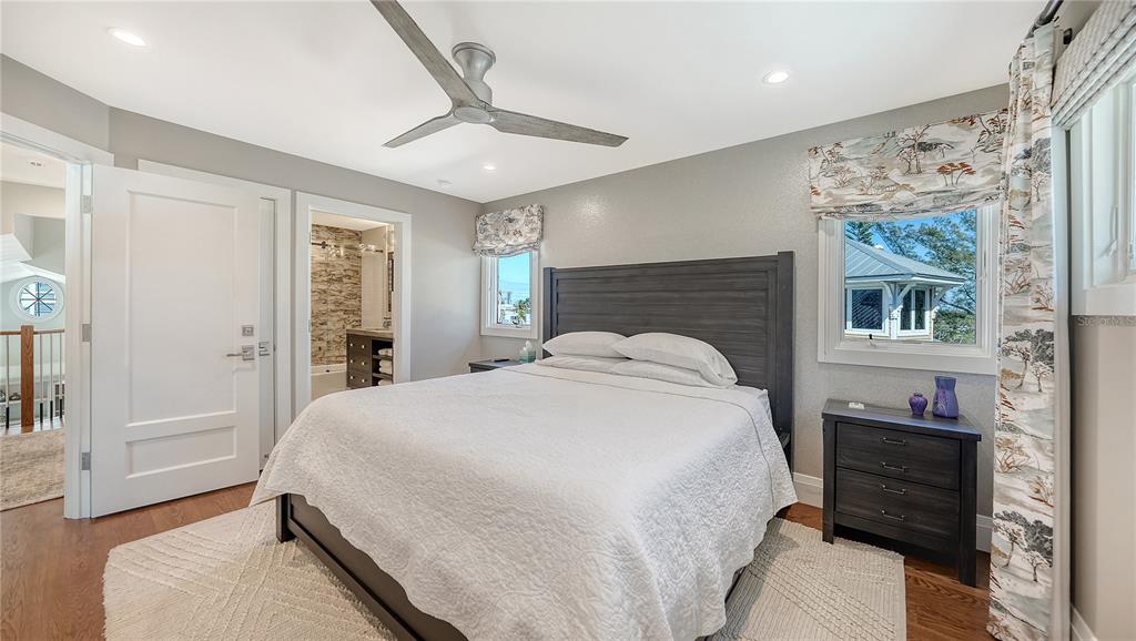95 52nd Street Holmes Beach, FL 34217 - Photo 38 of 73 a bedroom with a bed and a chandelier