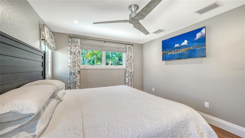 95 52nd Street Holmes Beach, FL 34217 - Photo 40 of 73 a bedroom with a large bed and a window