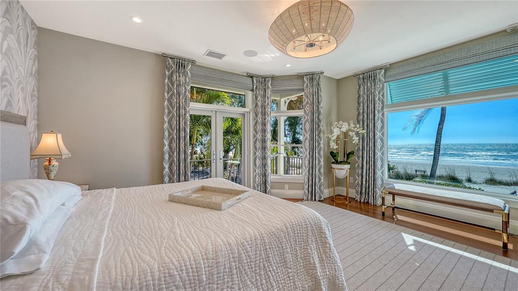 95 52nd Street Holmes Beach, FL 34217 - Photo 46 of 73 a bedroom with a large bed and a large window