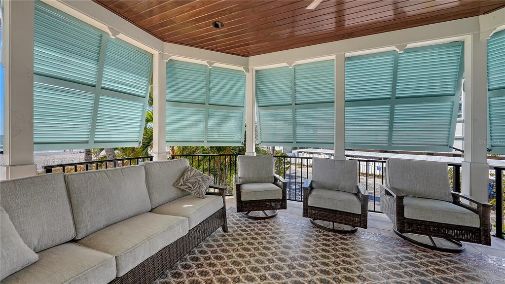 95 52nd Street Holmes Beach, FL 34217 - Photo 47 of 73 a balcony with furniture and a potted plant