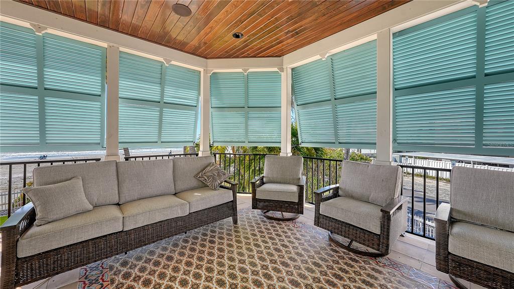 95 52nd Street Holmes Beach, FL 34217 - Photo 48 of 73 a balcony with furniture and a potted plant