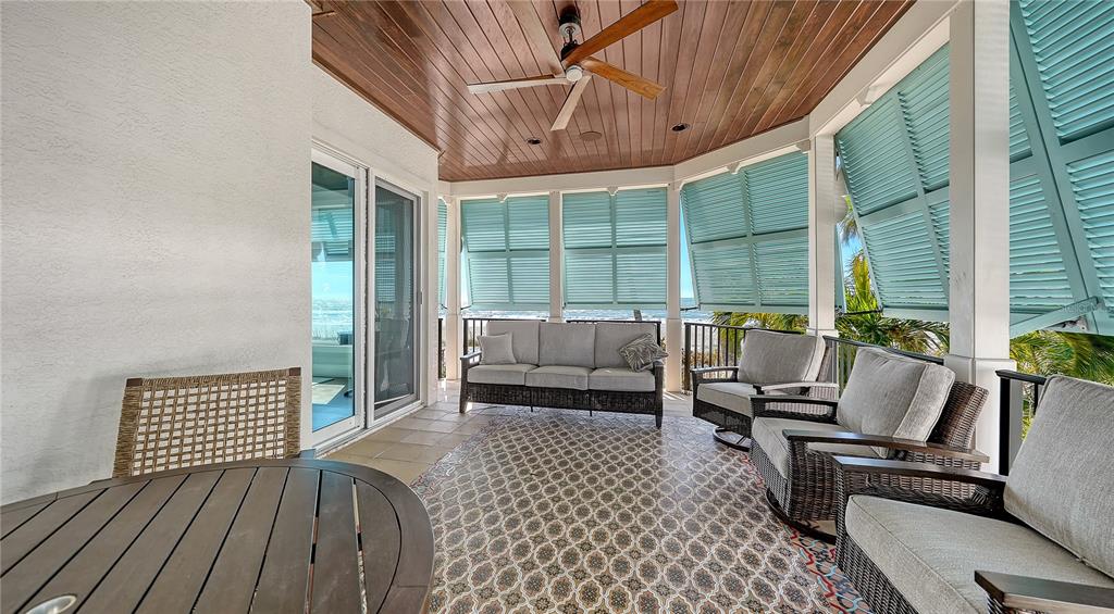 95 52nd Street Holmes Beach, FL 34217 - Photo 49 of 73 a balcony with furniture and wooden floor