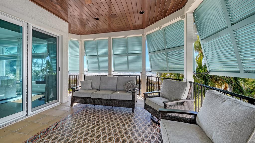 95 52nd Street Holmes Beach, FL 34217 - Photo 50 of 73 a balcony with furniture and wooden floor