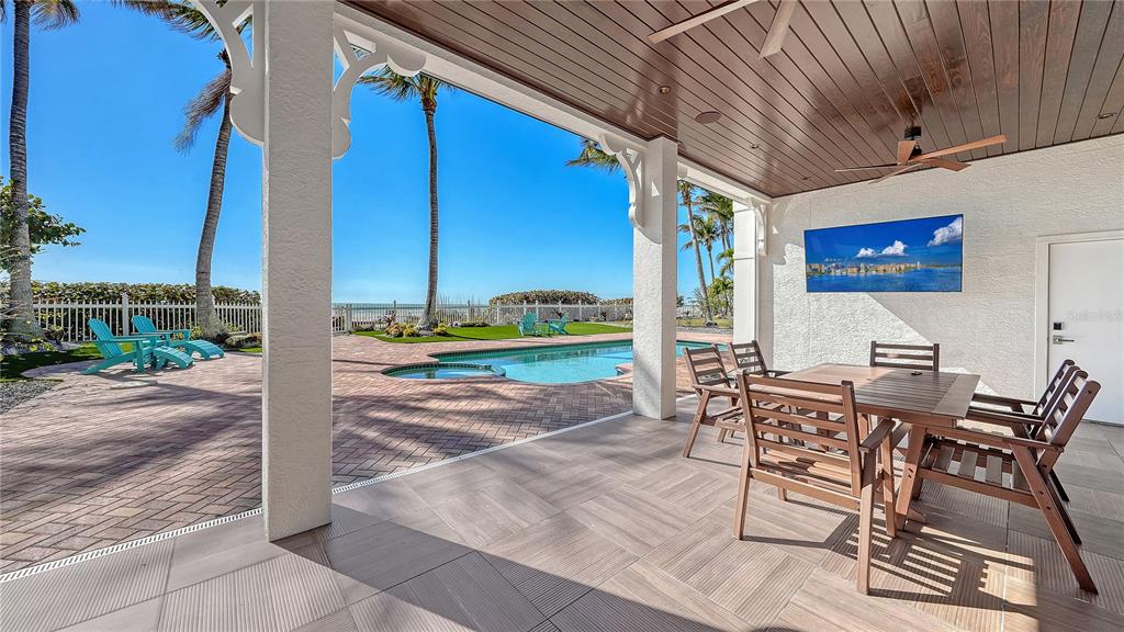 95 52nd Street Holmes Beach, FL 34217 - Photo 61 of 73 a view of a patio with table and chairs with wooden floor