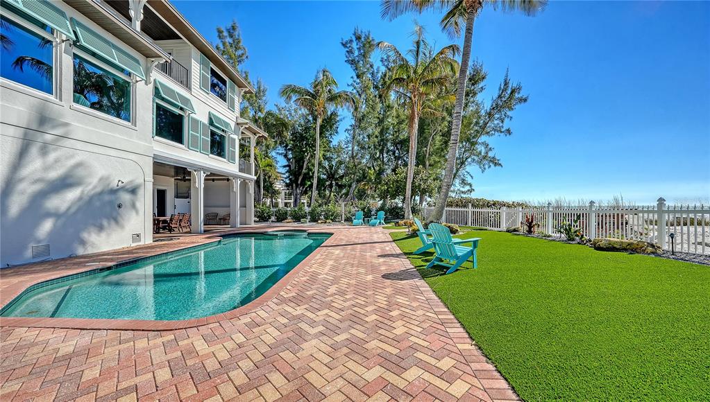 95 52nd Street Holmes Beach, FL 34217 - Photo 66 of 73 a view of a swimming pool with a garden