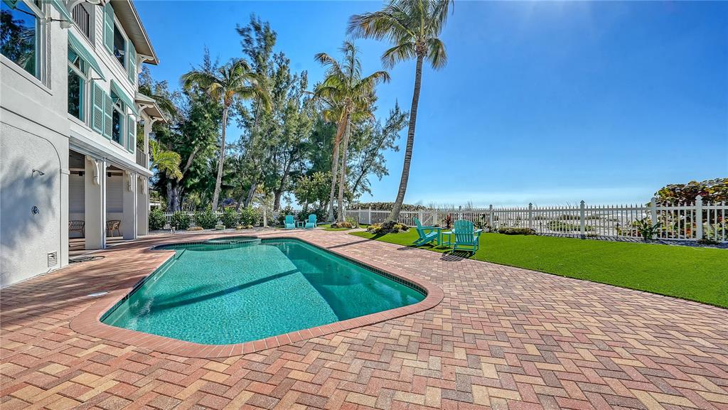 95 52nd Street Holmes Beach, FL 34217 - Photo 67 of 73 a view of a swimming pool with a yard