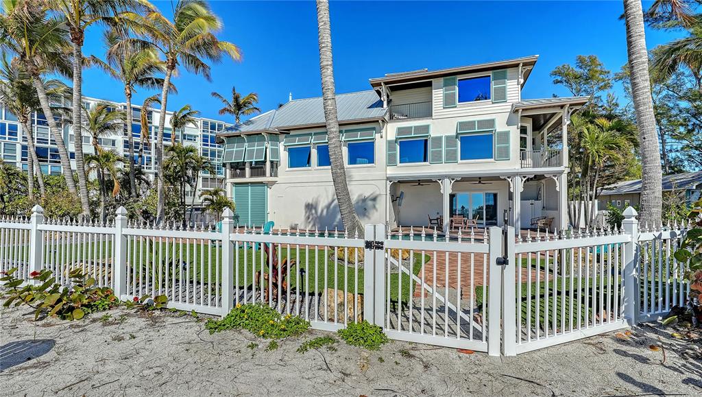 95 52nd Street Holmes Beach, FL 34217 - Photo 69 of 73 a front view of a house with a garden
