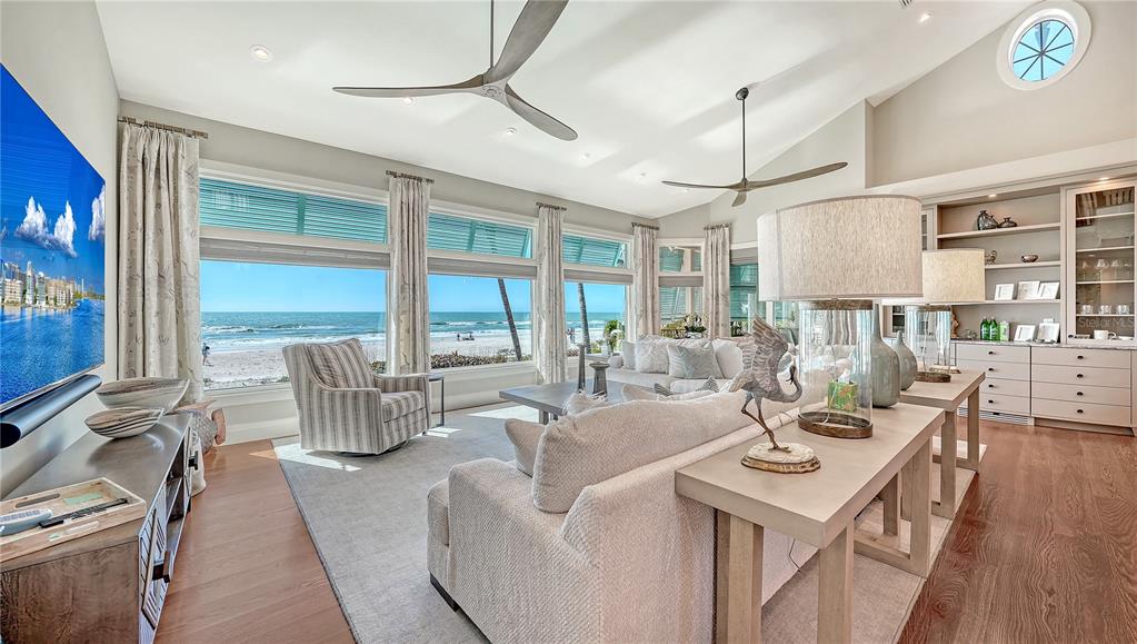 95 52nd Street Holmes Beach, FL 34217 - Photo 8 of 73 a living room with furniture a large window and wooden floor